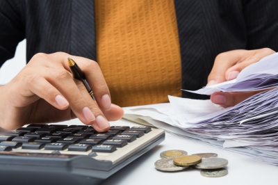 Woman paying and reviewing monthly bills